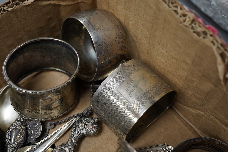 A small collection of silver including a George V mounted oval trinket box, Birmingham, 1916, 95mm, a sugar caster, five assorted napkin rings, five teaspoons, a pair of sugar tongs, handled glove stretchers and button h